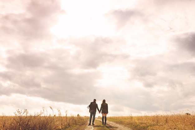 Landscape portrait of young beautiful stylish couple sensual and having fun outdoor