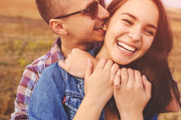 Free photo landscape portrait of young beautiful stylish couple sensual and having fun outdoor