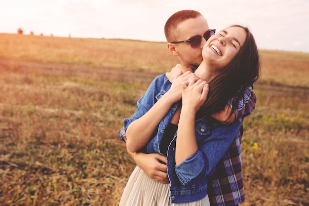 Landscape portrait of young beautiful stylish couple sensual and having fun outdoor