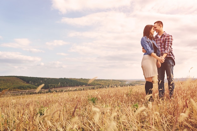 Landscape portrait of young beautiful stylish couple sensual and having fun outdoor