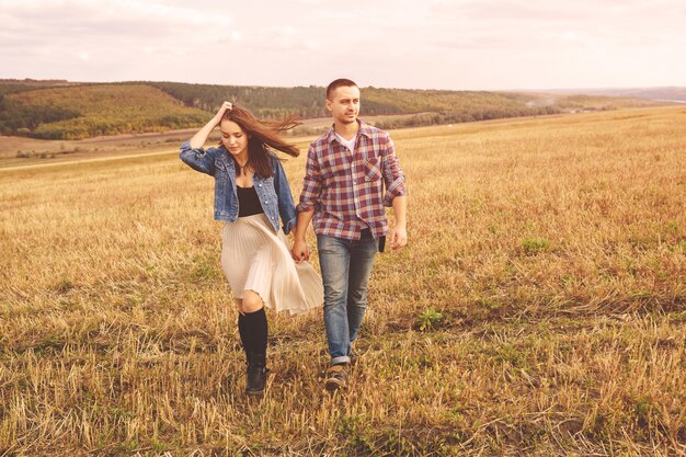 Landscape portrait of young beautiful stylish couple sensual and having fun outdoor