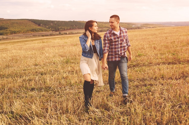 Free photo landscape portrait of young beautiful stylish couple sensual and having fun outdoor