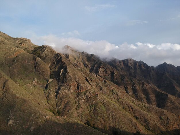 Landscape of rocky mountain ranges surrounded by clouds