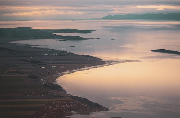 Landscape of Saint Lawrence River under a cloudy sky and sunlight in Kamouraska