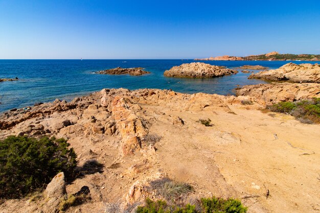 Landscape shot of a seashore with a clear blue sky