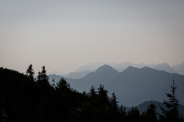 Landscape shot of a silhouette mountain with a clear sky in the background