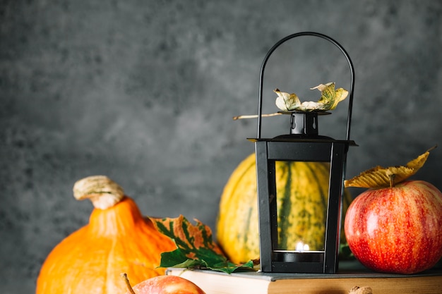 Lantern in foliage on books