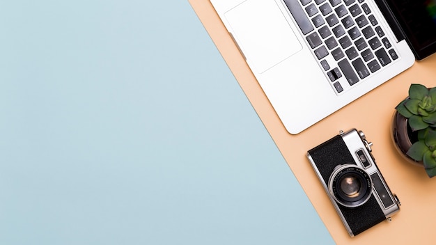 Free Photo laptop and camera on colorful background