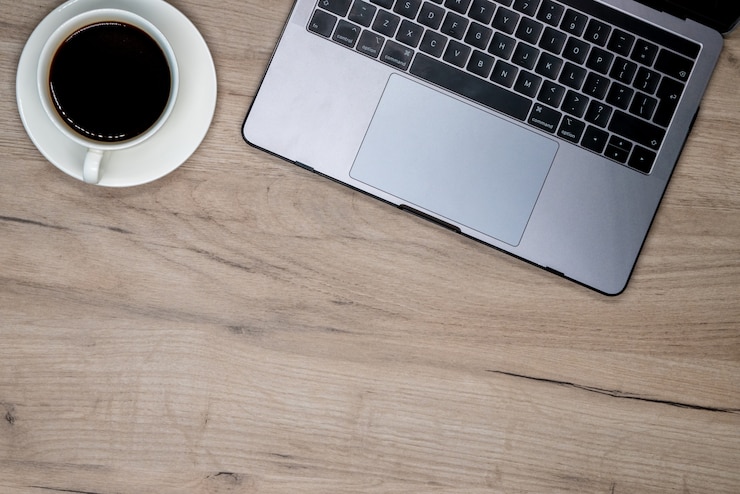 Free Photo laptop and cup of coffee
