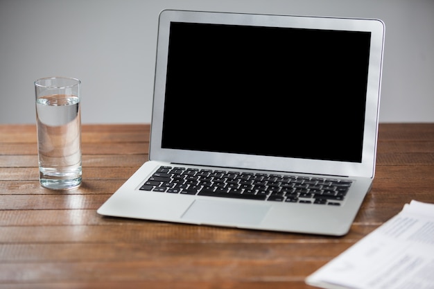 Laptop and glass of water