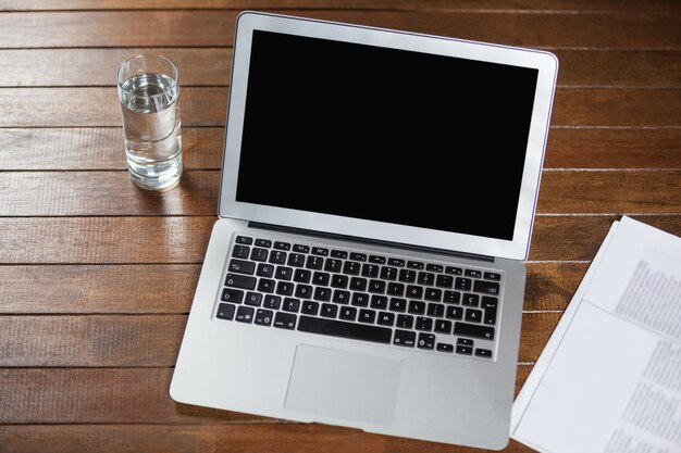 Laptop and glass of water