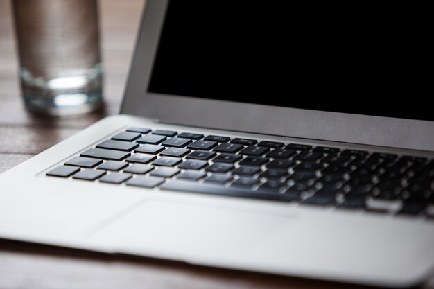 Laptop and glass of water