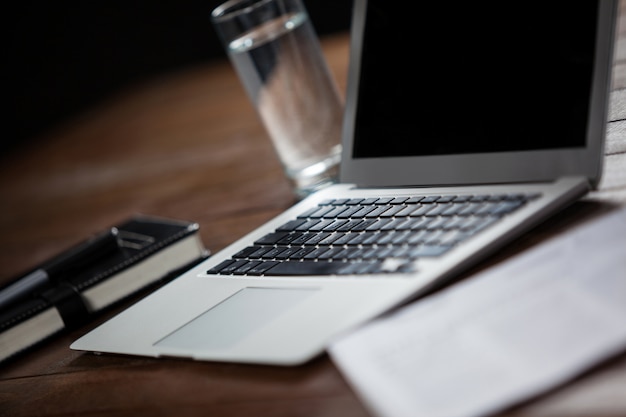 Laptop and glass of water