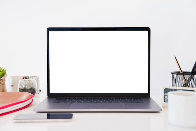 Laptop and items on desk arrangement