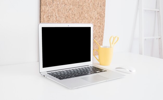 Laptop and mouse at workplace