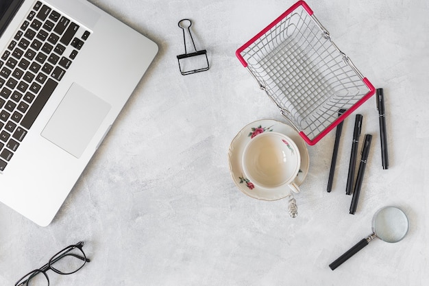 Free Photo laptop near stationery and supermarket basket