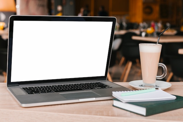 Laptop and notebook on wooden surface mockup