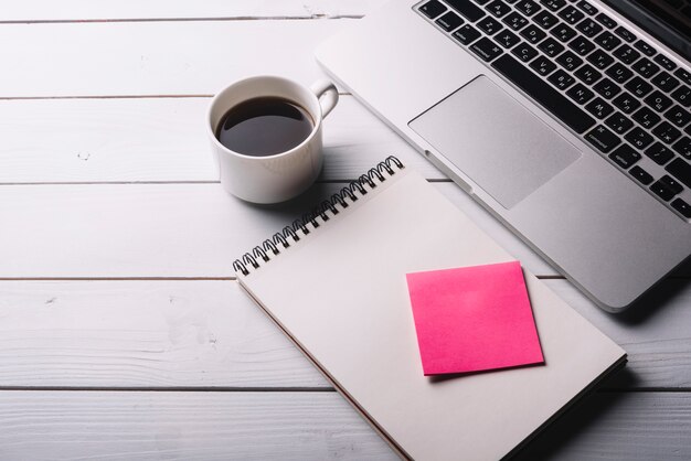 Laptop and notepad composition on desk