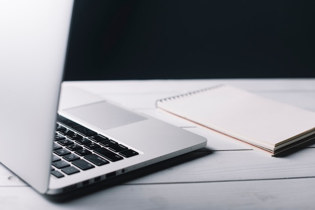 Laptop and notepad composition on desk