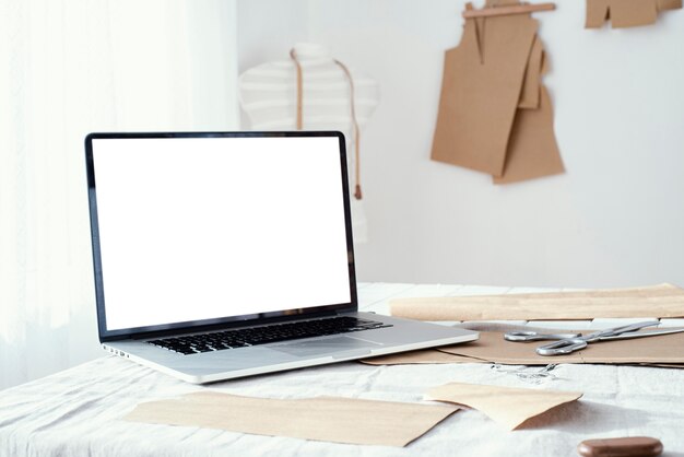 Laptop on the table in the tailoring studio