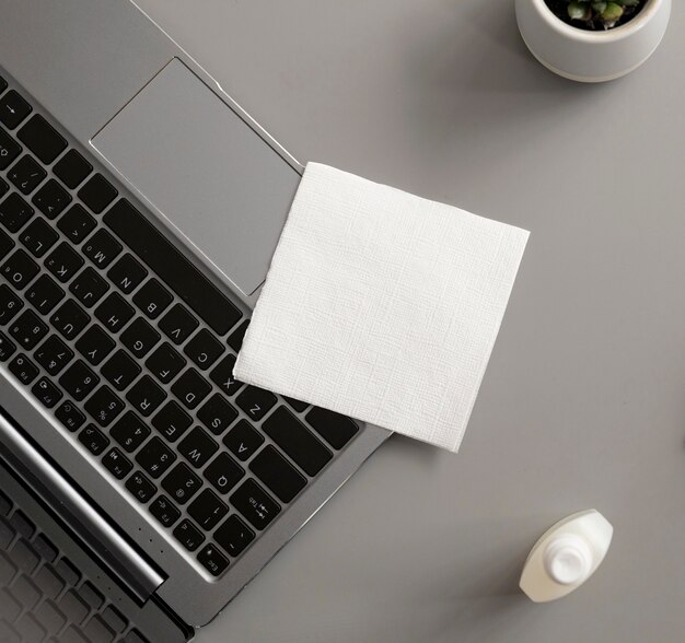 Laptop with disinfectant at the office