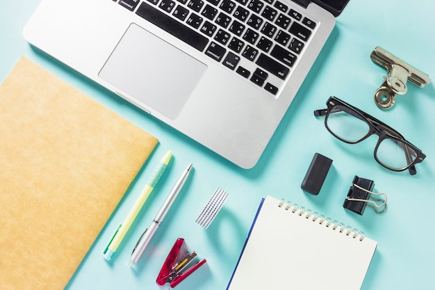 Laptop with office accessories on table