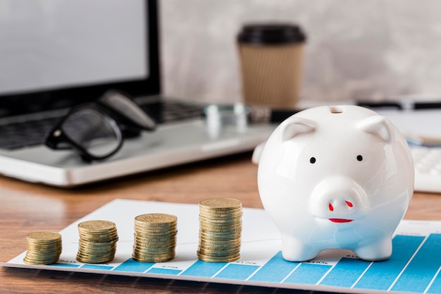 Laptop with piggy bank and growth chart