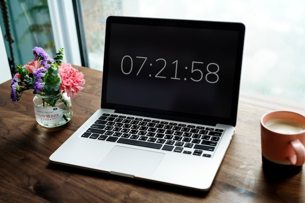 Laptop on wooden table with timer