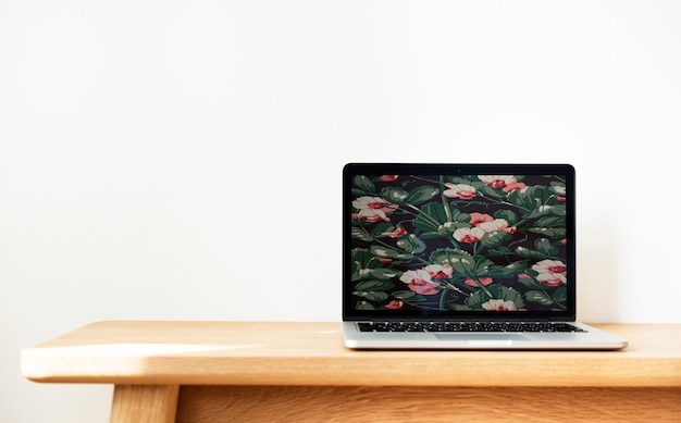 Free photo laptop on a wooden table