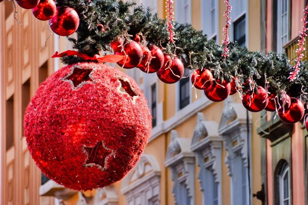 Large circular Christmas toy hanging around others in a line