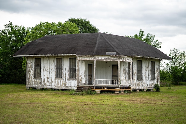 Large format shot of an old white house in the wood