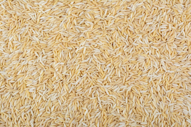 Large heap of raw long-grain brown rice