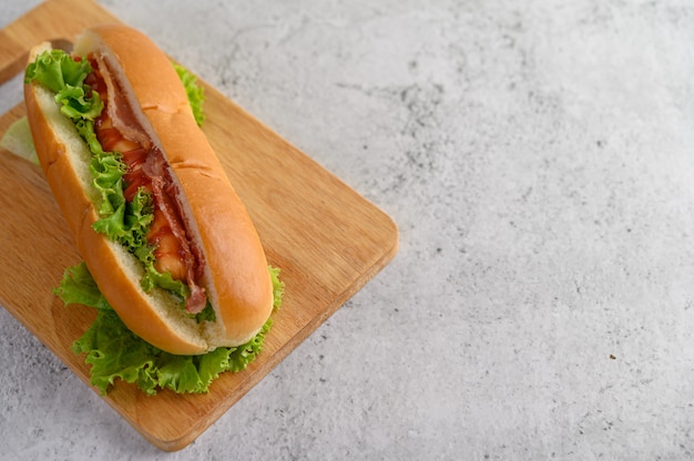 Large hot dog on wood cutting board