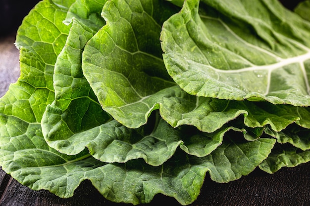 Large kale leaves, loose and green, used in cooking.
