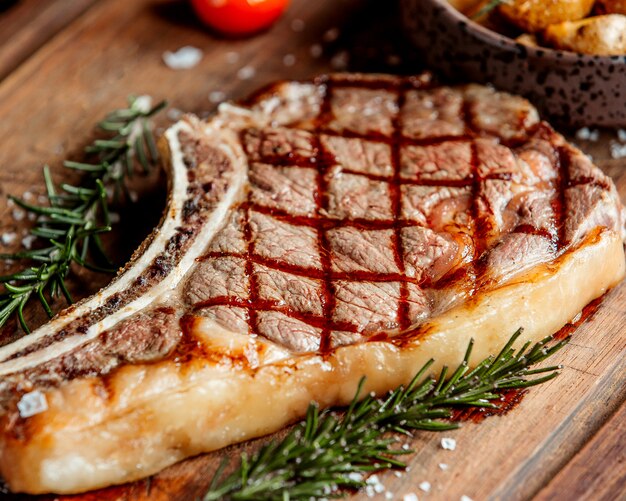 A large piece of steak with tarragon leaves