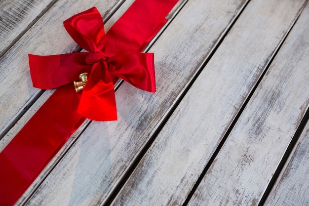 Large red ribbon on a wooden table