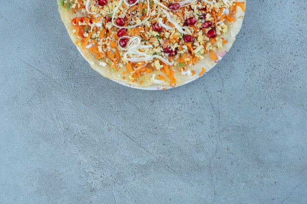 Large serving of cheese and walnut salad on marble.