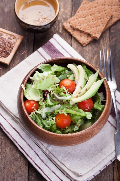 Large wooden bowl with salad seen from above