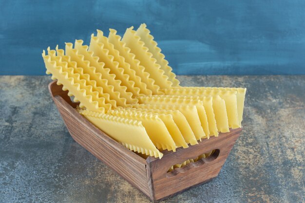 Lasagna sheets in the box , on the marble background.