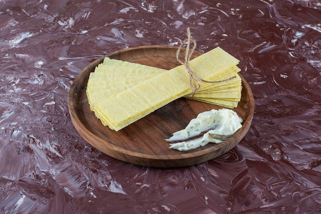 Free photo lasagna sheets with yogurt on a wooden plate , on the marble table.