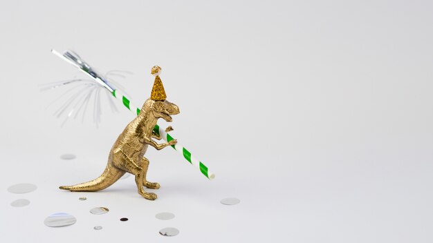 Lateral view golden t-rex with birthday hat