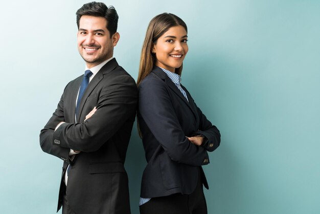 Latin confident professionals in suit standing against isolated background