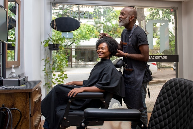 Free photo latino hair salon owner taking care of client