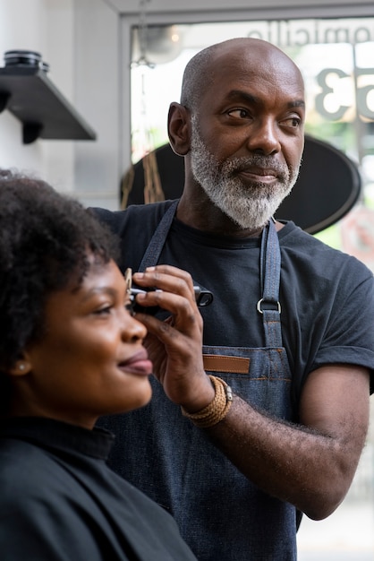 Free photo latino hair salon owner taking care of client