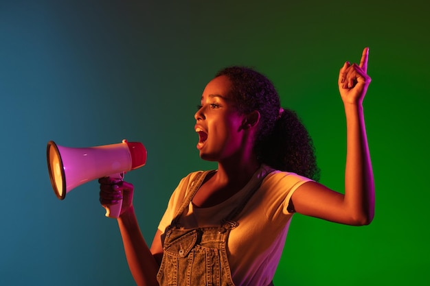 Free photo latino young woman isolated on studio background in neon concept of human emotions facial expression