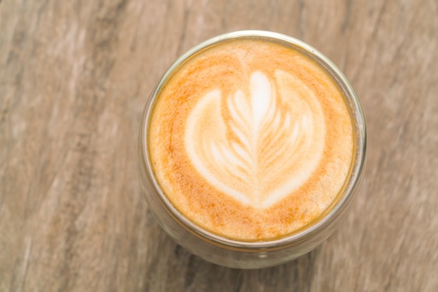 Latte Coffee art on the wooden table .