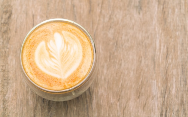 Latte Coffee art on the wooden table .