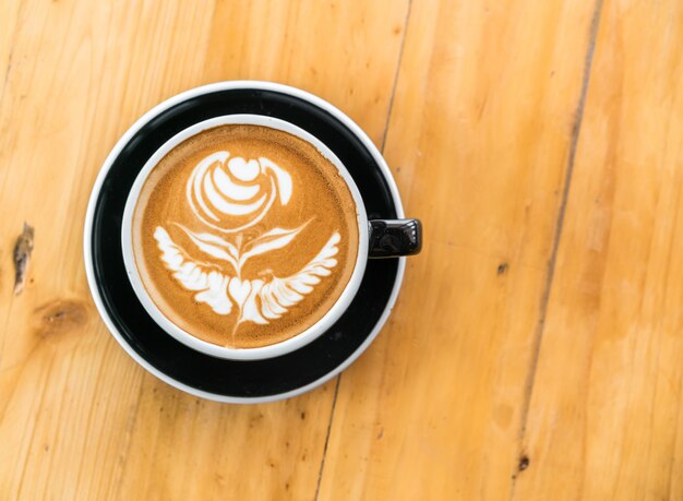 Latte Coffee art on the wooden table .