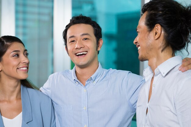 Laughing Asian colleague looking at camera