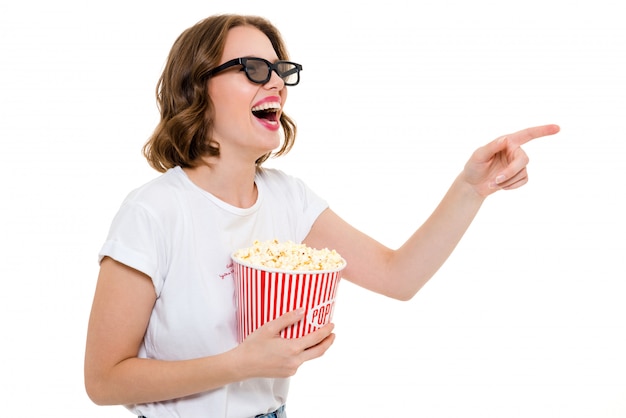 Laughing caucasian woman holding pop corn watch film.